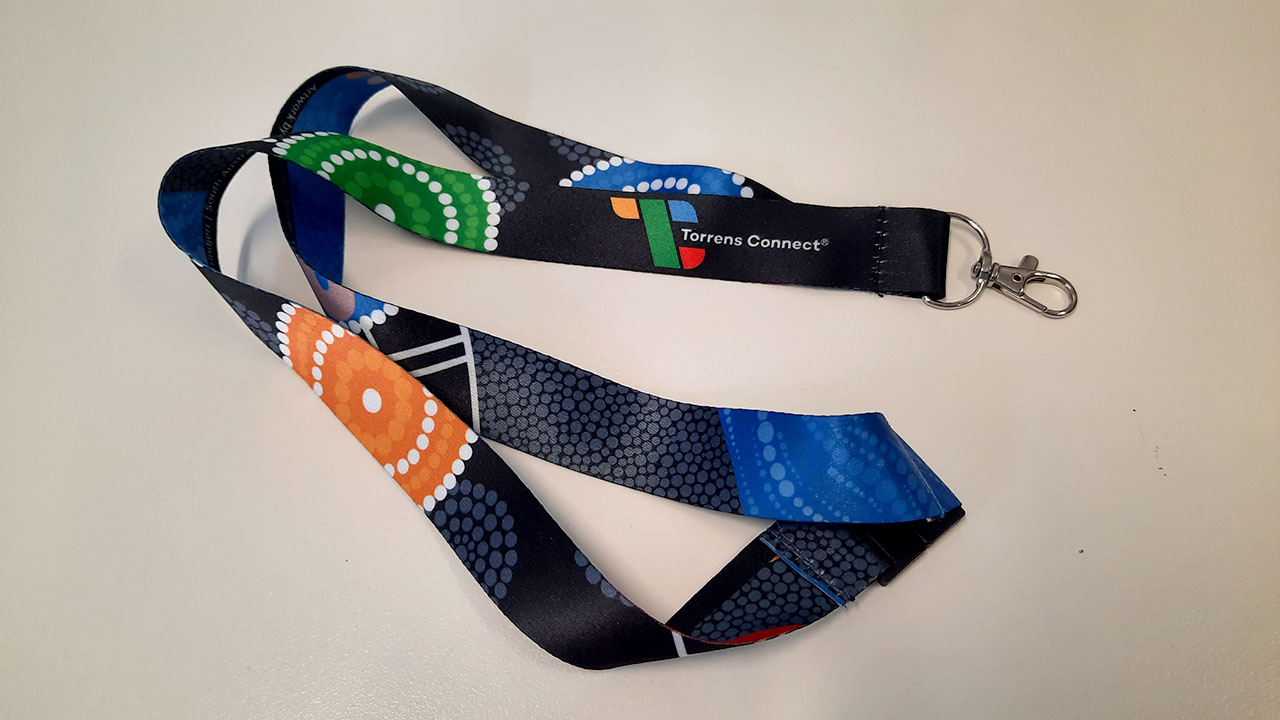 A Torrens Connect lanyard featuring artwork from the painting.